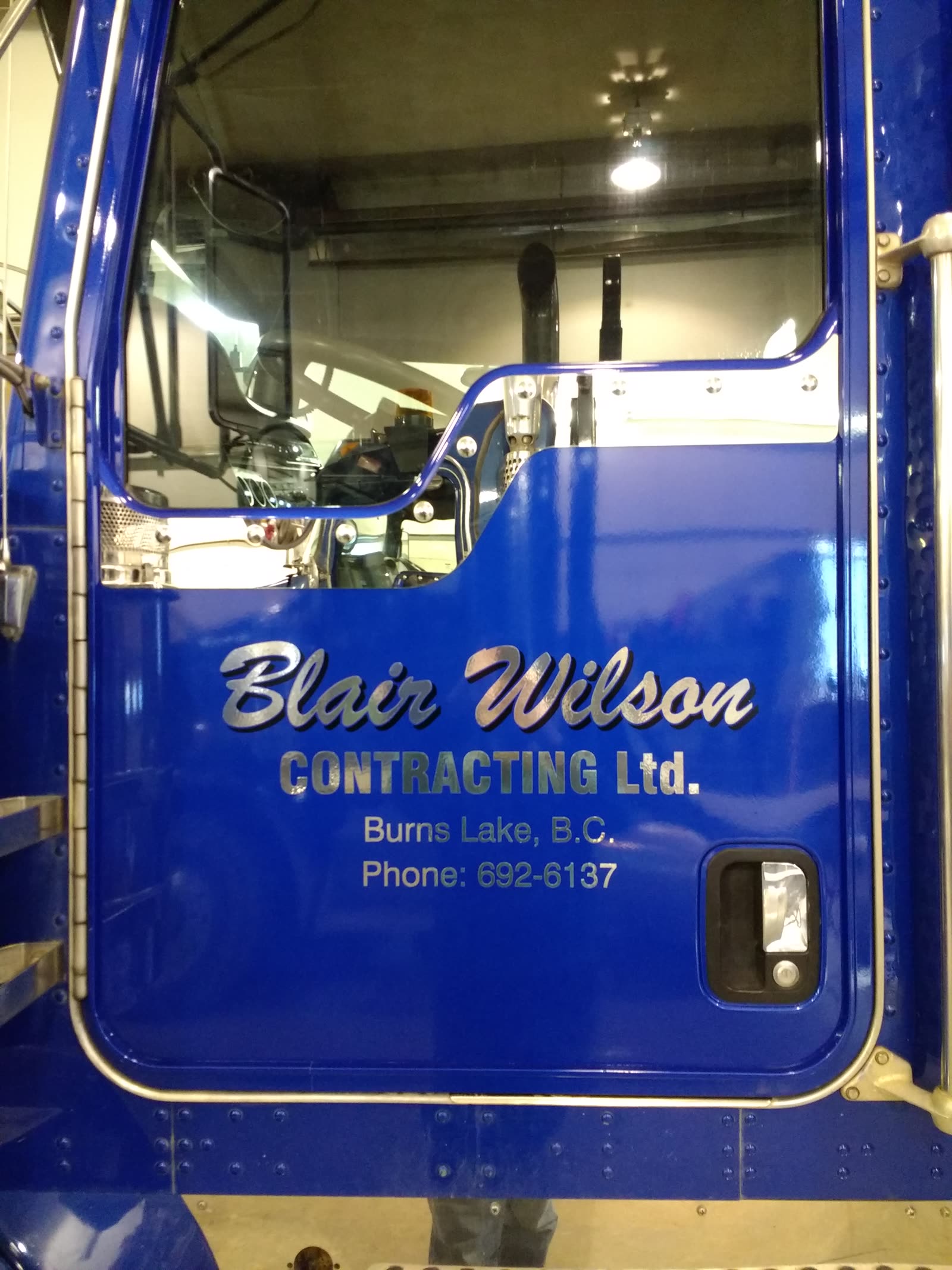 Metallic vinyl door lettering on a Blair Wilson Contracting truck